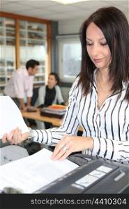 Woman using an office photocopier