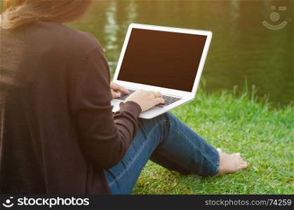 woman using blank screen laptop at a outdoors