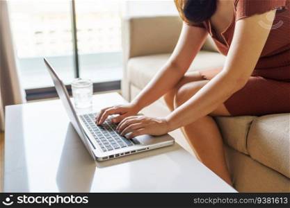woman using computer laptop for work online at living room