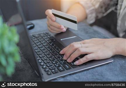 Woman using credit card filling billing information on laptop computer shopping in ecommerce store. concept : online payment, accessible internet money transaction
