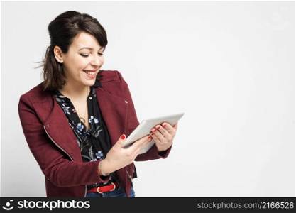 Woman using digital tablet computer happy isolated on white background. Portrait young hispanic woman worker, teacher, mentoring in shirt office style with tablet in hand