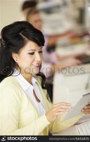 Woman Using Digital Tablet In Busy Creative Office