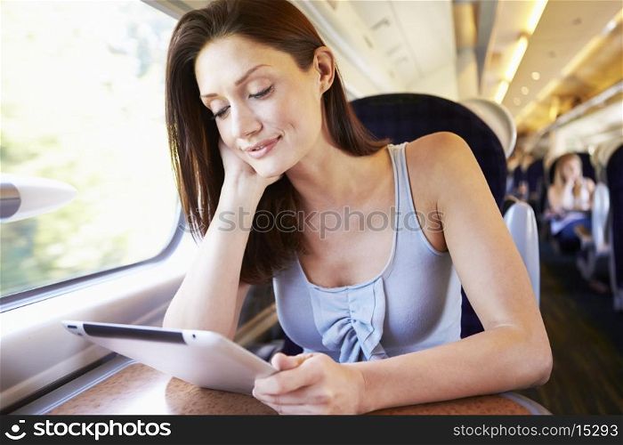 Woman Using Digital Tablet On Train