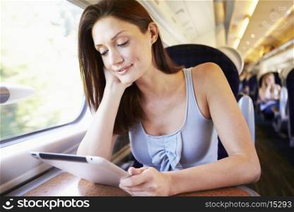 Woman Using Digital Tablet On Train