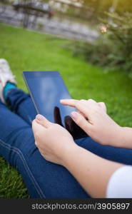 Woman using digital tablet PC in the park