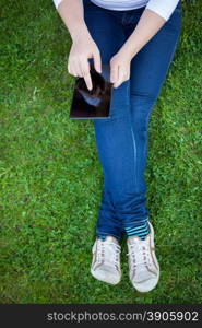 Woman using digital tablet PC in the park