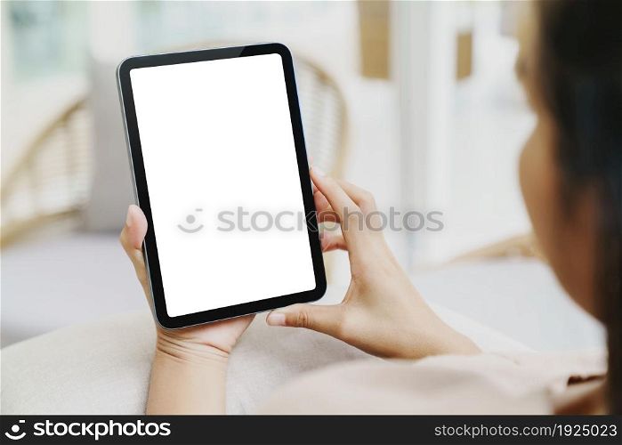 woman using digital tablet rear view shot