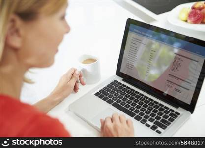 Woman Using Digital Tablet To Write Shopping List At Home