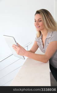 Woman using electronic tablet at home