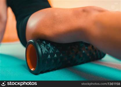 Woman Using Foam Roller for Muscle and Fascia Stretching. Using Foam Roller for Muscle and Fascia Massage
