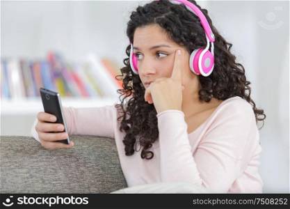 woman using headphones while listening to music