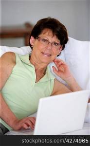 Woman using her laptop in her living room