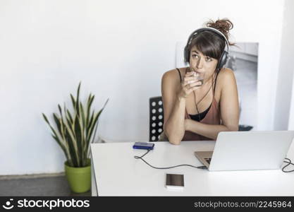 Woman using laptop and working from home. Isabella Antonelli