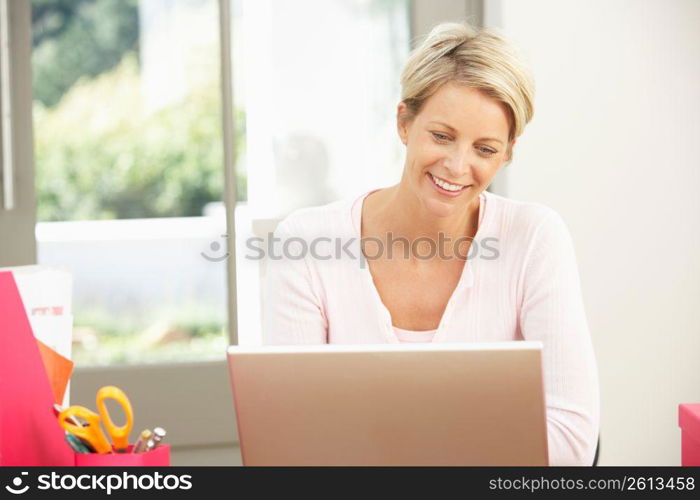 Woman Using Laptop At Home