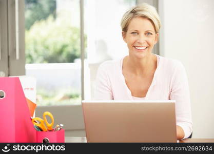 Woman Using Laptop At Home