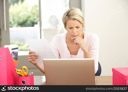 Woman Using Laptop At Home