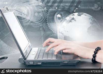 Woman using laptop. Close up of female hands typing on laptop keyboard