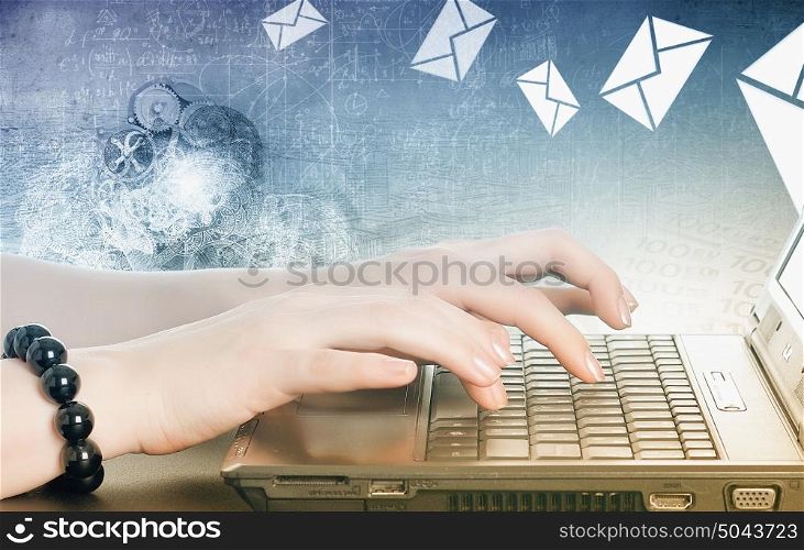 Woman using laptop. Close up of female hands typing on laptop keyboard