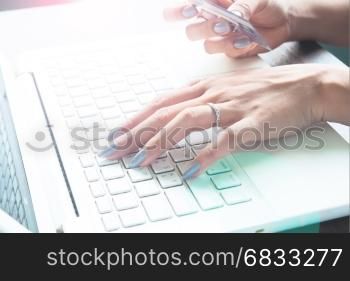 Woman using laptop computer and credit card, Online shopping