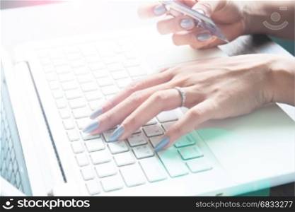 Woman using laptop computer and credit card, Online shopping