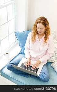 Woman using laptop computer at home