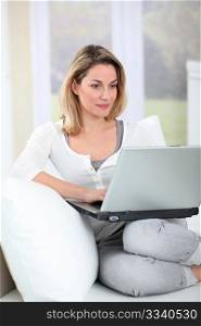 Woman using laptop computer at home
