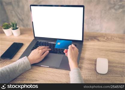 woman using laptop computer do online activity pay credit card on wood table.