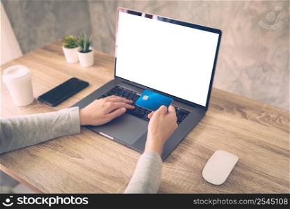 woman using laptop computer do online activity pay credit card on wood table.