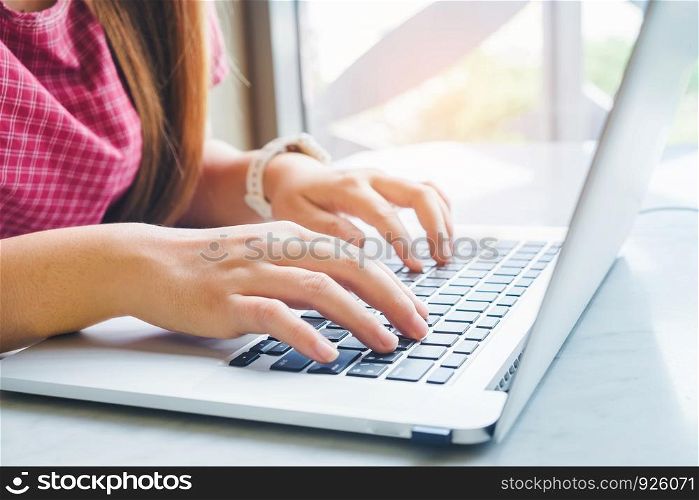Woman using laptop computer. Female working on laptop in an outdoor cafe.