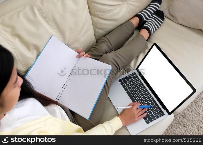 Woman using laptop computer with blank screen for mock up template background, technology and lifestyle, working at home background concept