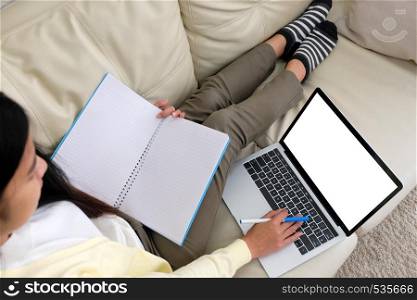 Woman using laptop computer with blank screen for mock up template background, technology and lifestyle, working at home background concept