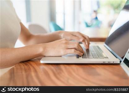 woman using laptop, freelance woman typing keyboard computer notebook in cafe or modern office. technology, digital online and network concept