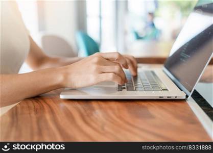 woman using laptop, freelance woman typing keyboard computer notebook in cafe or modern office. technology, digital online and network concept