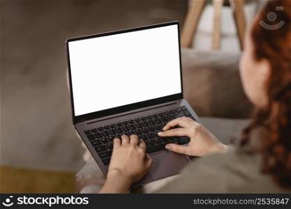 woman using laptop home couch