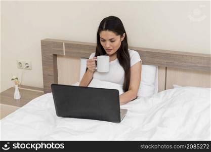 woman using laptop hotel room