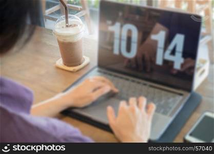 Woman using laptop in the coffee shop, stock photo