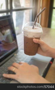 Woman using laptop in the coffee shop, stock photo