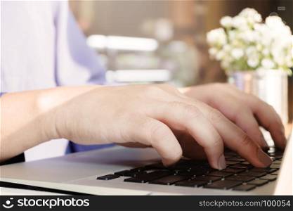 woman using laptop, searching web, browsing information, having work at cafe