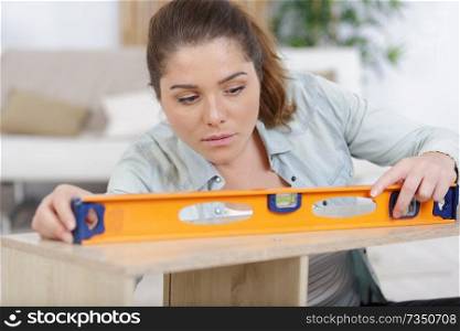 woman using leveling tool