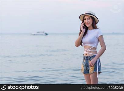 woman using mobile phone on the sea beach. beautiful woman using mobile phone on the sea beach