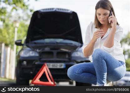 woman using mobile phone to notify car accident