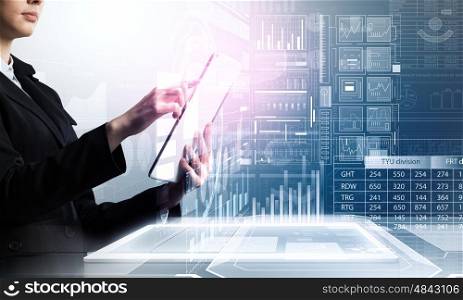 Woman using modern technologies. Businesswoman with tablet pc against high tech background