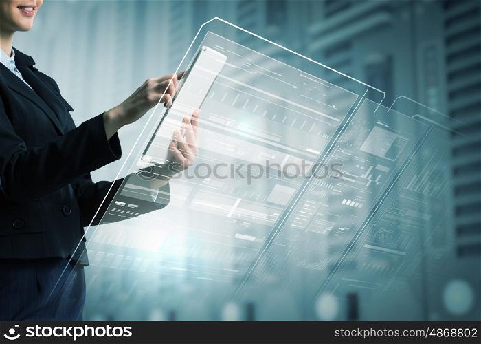 Woman using modern technologies. Businesswoman with tablet pc against high tech background