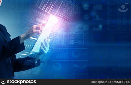 Woman using modern technologies. Businesswoman with tablet pc against high tech background