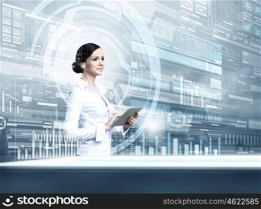 Woman using modern technologies. Businesswoman with tablet pc against high tech blue background