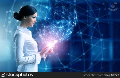 Woman using modern technologies. Businesswoman with tablet pc against high tech blue background