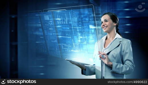 Woman using modern technologies. Businesswoman with tablet pc against high tech blue background