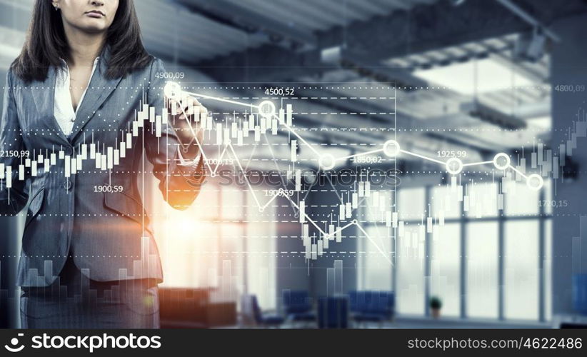 Woman using modern technologies for business. Chest view of businesswoman drawing infographs on screen