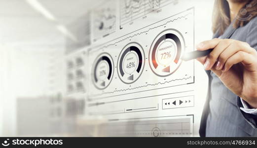 Woman using modern technologies for business. Chest view of businesswoman drawing infographs on screen