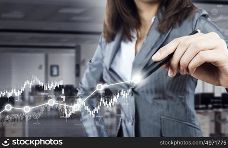 Woman using modern technologies for business. Chest view of businesswoman drawing infographs on screen